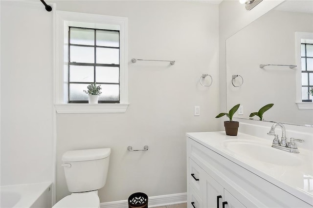 full bathroom with a healthy amount of sunlight, vanity, bathtub / shower combination, and toilet