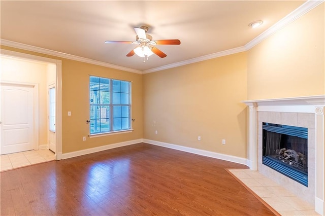 40145 Taylors Trl Unit 204, Slidell, LA 70461 - unfurnished living room with wood finished floors, ceiling fan, crown molding, and a tiled fireplace