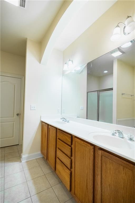 bathroom with vanity, a shower with door, and tile patterned floors