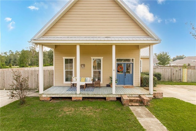 rear view of property with a lawn