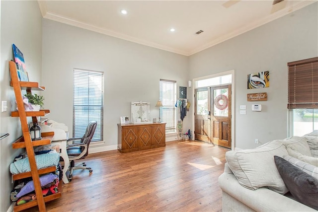 office space with crown molding and light hardwood / wood-style floors