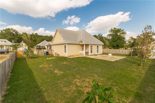 back of house featuring a yard, cooling unit, and a patio area