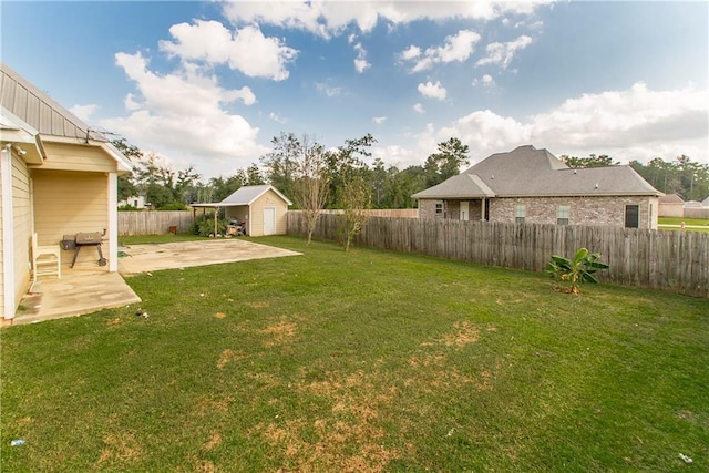 view of yard with a storage shed and a patio