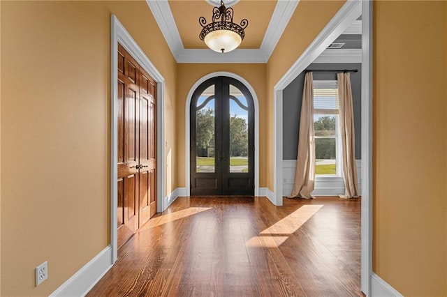 65520 S Hickory Dr, Pearl River, LA 70452 - entrance foyer with french doors, wood finished floors, ornamental molding, baseboards, and arched walkways