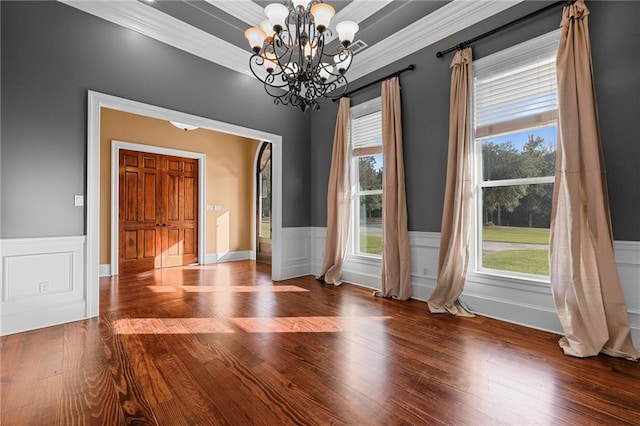 interior space with wood-type flooring, ornamental molding, and a chandelier