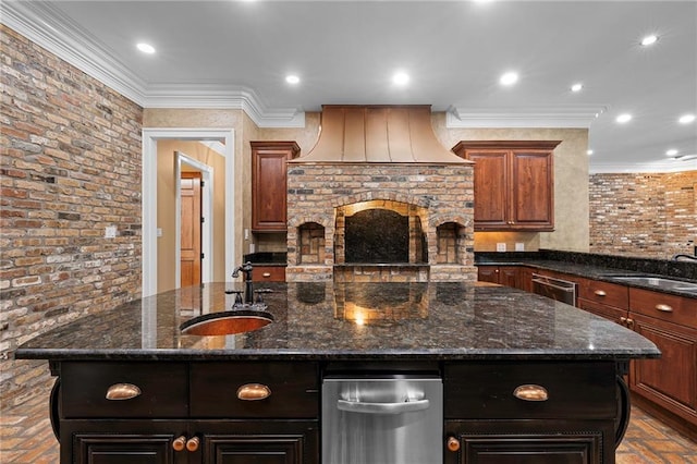 65520 S Hickory Dr, Pearl River, LA 70452 - kitchen with a sink, dishwasher, an island with sink, dark stone counters, and ornamental molding