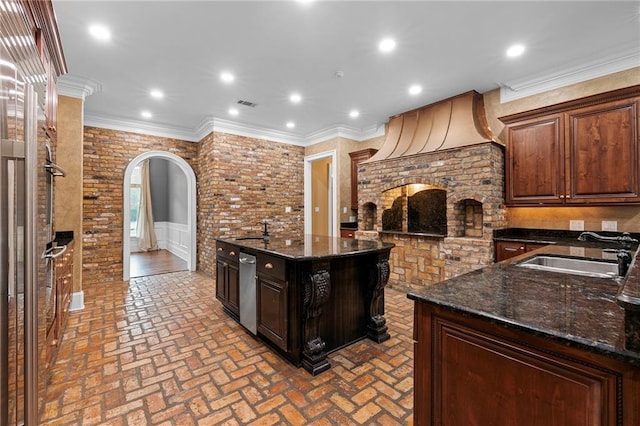 65520 S Hickory Dr, Pearl River, LA 70452 - kitchen with a sink, brick floors, arched walkways, dark stone countertops, and recessed lighting