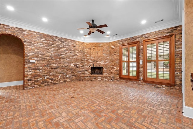 65520 S Hickory Dr, Pearl River, LA 70452 - unfurnished living room featuring ceiling fan, arched walkways, brick flooring, a fireplace, and recessed lighting