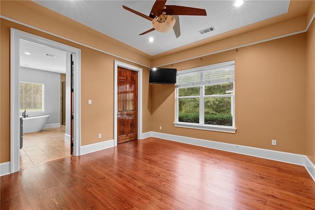 unfurnished bedroom with hardwood / wood-style flooring and ceiling fan