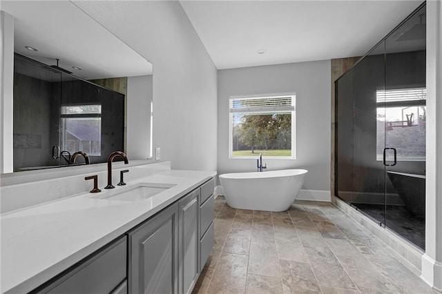 65520 S Hickory Dr, Pearl River, LA 70452 - full bath featuring a stall shower, vanity, a freestanding bath, and baseboards