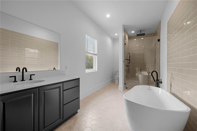 65520 S Hickory Dr, Pearl River, LA 70452 - full bathroom featuring a stall shower, a freestanding bath, vanity, tile patterned flooring, and recessed lighting