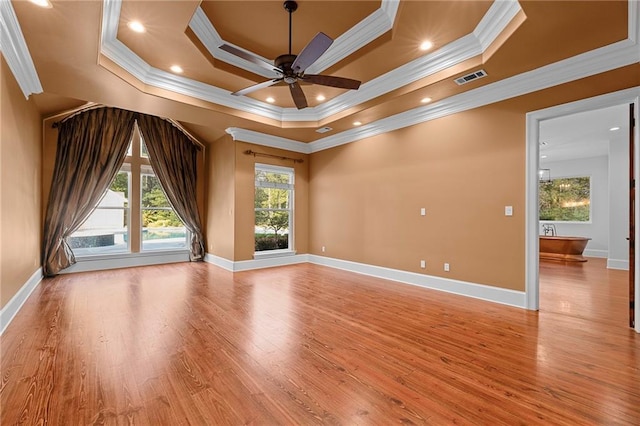 65520 S Hickory Dr, Pearl River, LA 70452 - spare room with crown molding, light wood finished floors, a ceiling fan, a tray ceiling, and baseboards