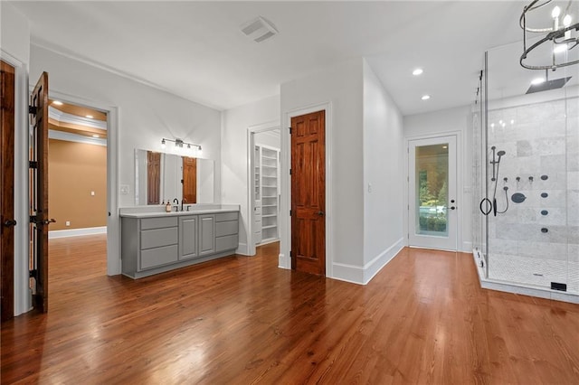 bathroom with vanity, hardwood / wood-style flooring, and walk in shower