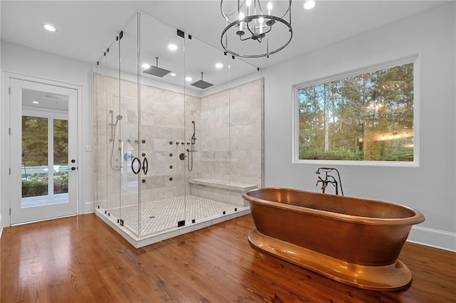 65520 S Hickory Dr, Pearl River, LA 70452 - bathroom with a shower stall, wood finished floors, a chandelier, recessed lighting, and a soaking tub