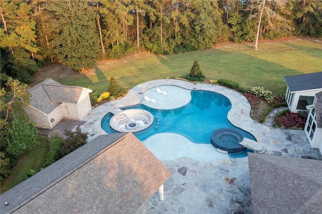 view of swimming pool with an in ground hot tub, a yard, and a patio area