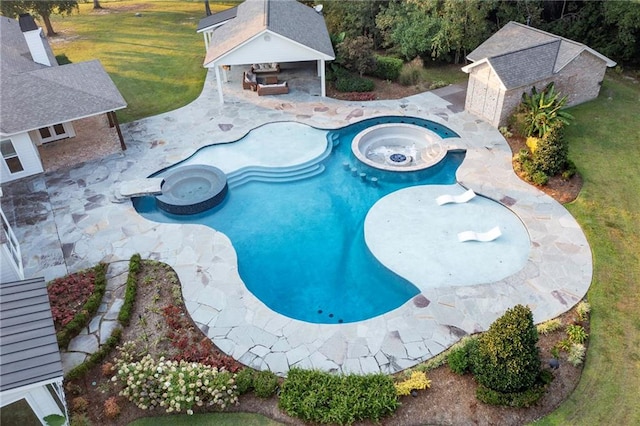 view of swimming pool featuring a patio, an outbuilding, a fireplace, an in ground hot tub, and a lawn