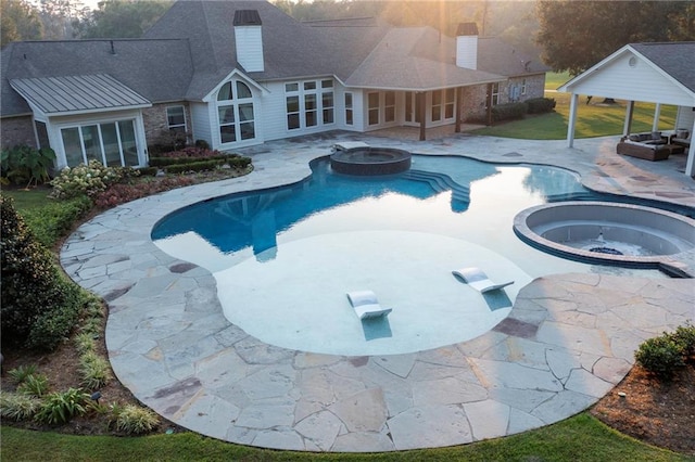 view of swimming pool with an in ground hot tub and a patio