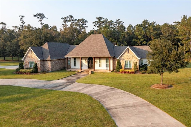 65520 S Hickory Dr, Pearl River, LA 70452 - view of front facade featuring driveway, a front lawn, and a porch