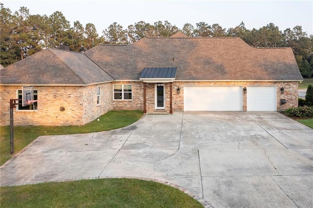 65520 S Hickory Dr, Pearl River, LA 70452 - view of front of property featuring concrete driveway, an attached garage, a front yard, and brick siding