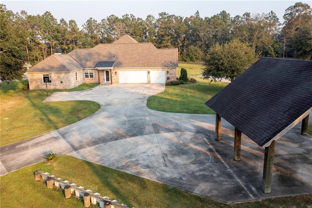 view of front of house with a garage and a front lawn