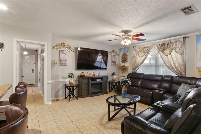 tiled living room featuring a textured ceiling and ceiling fan