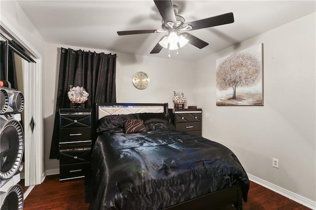 bedroom with ceiling fan and dark hardwood / wood-style floors