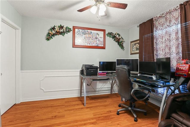 office area featuring light hardwood / wood-style floors, a textured ceiling, and ceiling fan