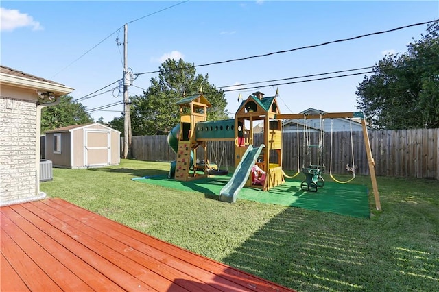 view of play area with a shed and a lawn