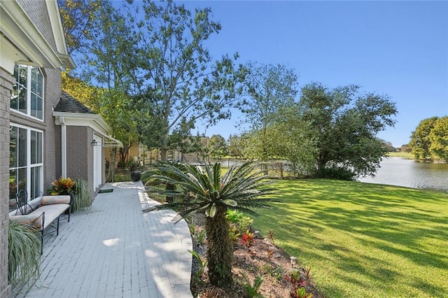 view of yard featuring a deck with water view