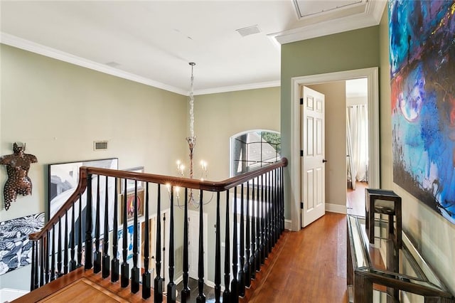 corridor featuring crown molding, dark hardwood / wood-style floors, and a chandelier