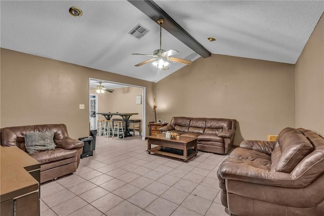 tiled living room featuring vaulted ceiling with beams, a textured ceiling, and ceiling fan