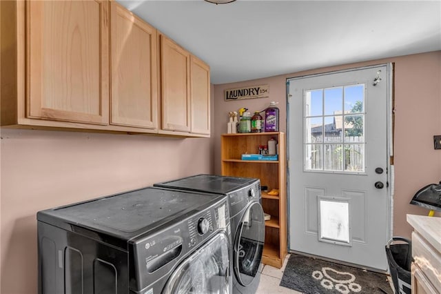 clothes washing area with cabinets and independent washer and dryer