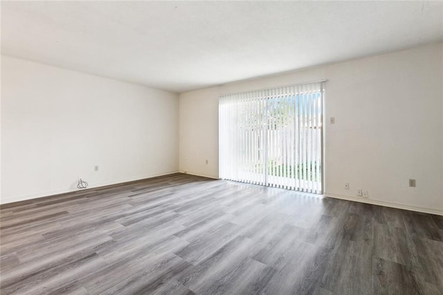 unfurnished room with wood-type flooring