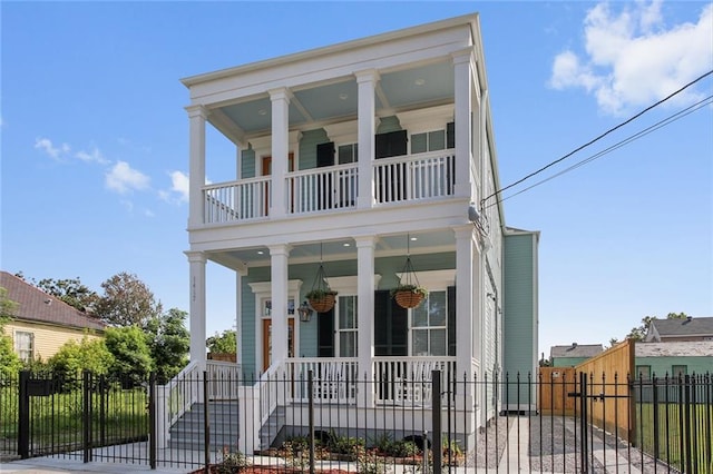 greek revival inspired property with a porch and a balcony