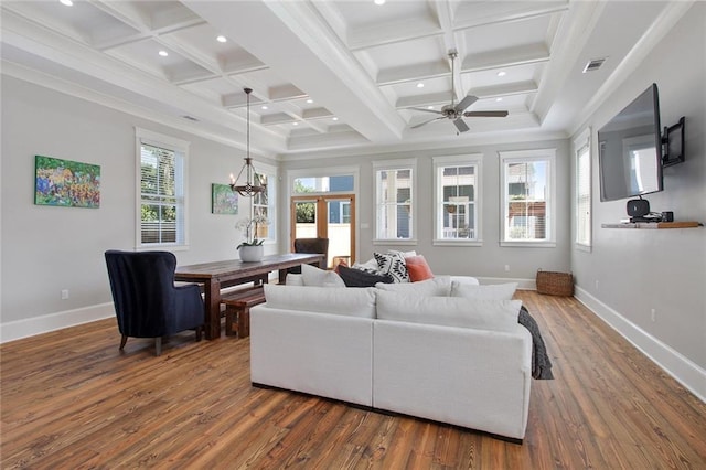 living room featuring coffered ceiling, ceiling fan with notable chandelier, dark hardwood / wood-style flooring, ornamental molding, and beam ceiling