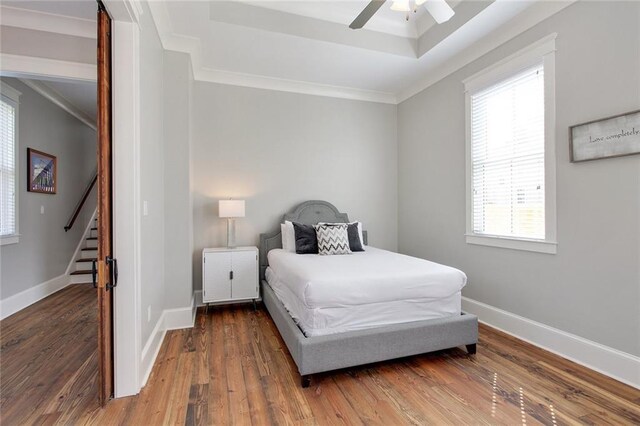 1417-1419 Esplanade Ave, New Orleans, LA 70116 - bedroom featuring wood finished floors, crown molding, a ceiling fan, and a tray ceiling