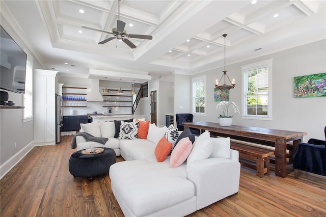 living room with coffered ceiling, beamed ceiling, crown molding, and wood-type flooring