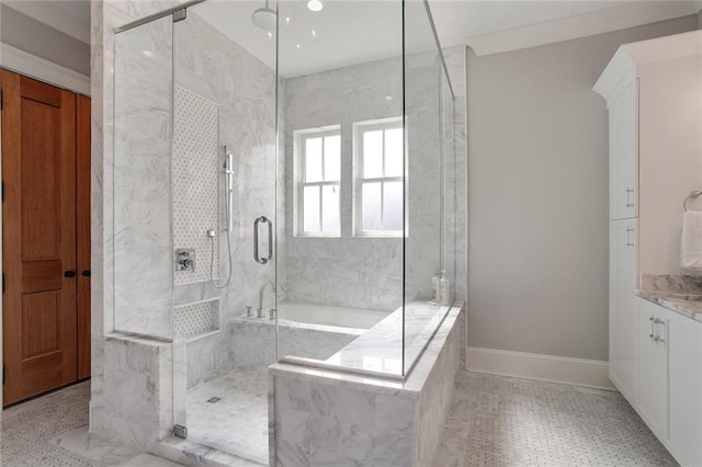 bathroom with vanity and independent shower and bath