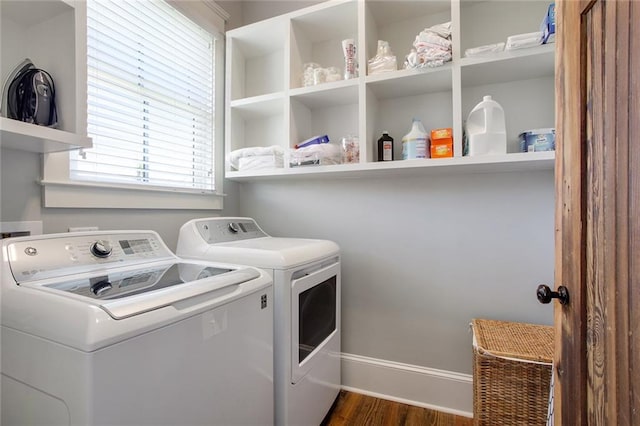 laundry area with washing machine and dryer and dark hardwood / wood-style floors