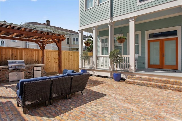 view of patio / terrace featuring french doors, exterior kitchen, area for grilling, a pergola, and an outdoor living space