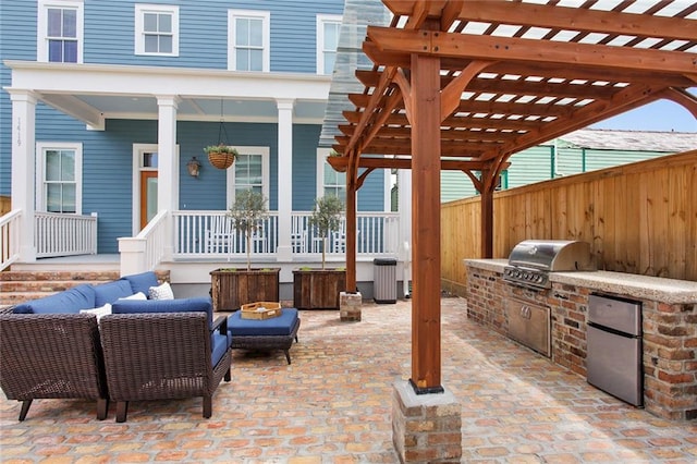 view of patio with a pergola, area for grilling, exterior kitchen, and an outdoor hangout area