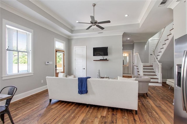 1417-1419 Esplanade Ave, New Orleans, LA 70116 - living area with dark wood-type flooring, a tray ceiling, ceiling fan, ornamental molding, and stairs