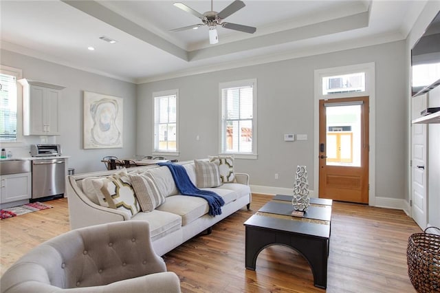 1417-1419 Esplanade Ave, New Orleans, LA 70116 - living room with a tray ceiling, crown molding, light wood-type flooring, a ceiling fan, and recessed lighting