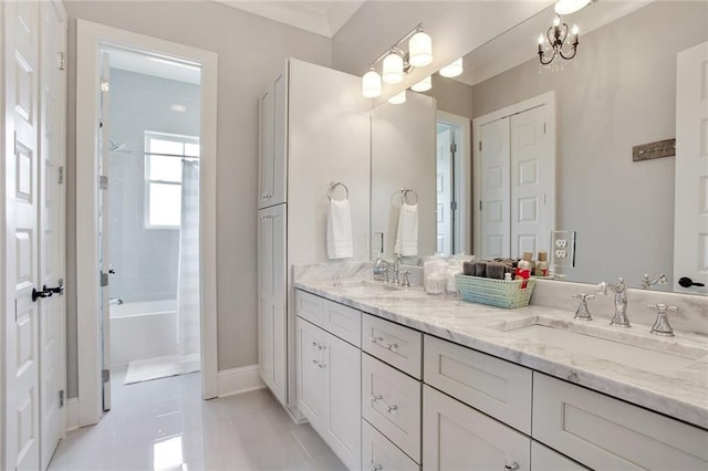 bathroom with tiled shower / bath combo, vanity, an inviting chandelier, and tile patterned floors