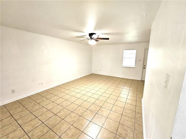 spare room with light tile patterned flooring and ceiling fan