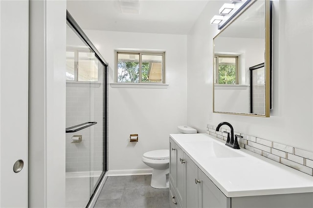 bathroom featuring vanity, toilet, walk in shower, and plenty of natural light