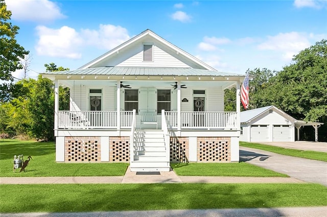 view of front facade featuring a garage, a front lawn, an outdoor structure, a porch, and ceiling fan