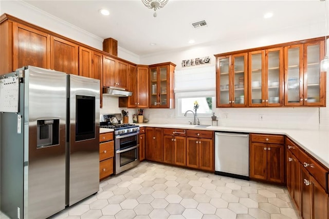 kitchen featuring sink, appliances with stainless steel finishes, and ornamental molding