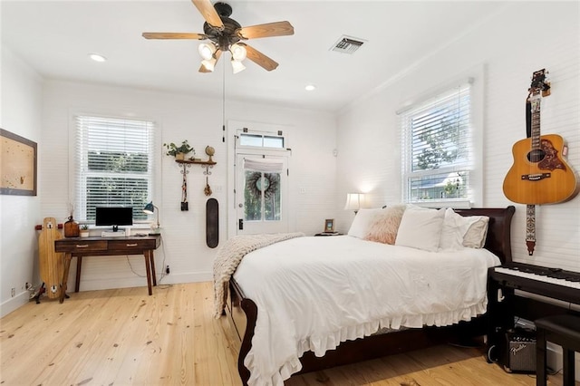 bedroom with multiple windows, light wood-type flooring, and ceiling fan