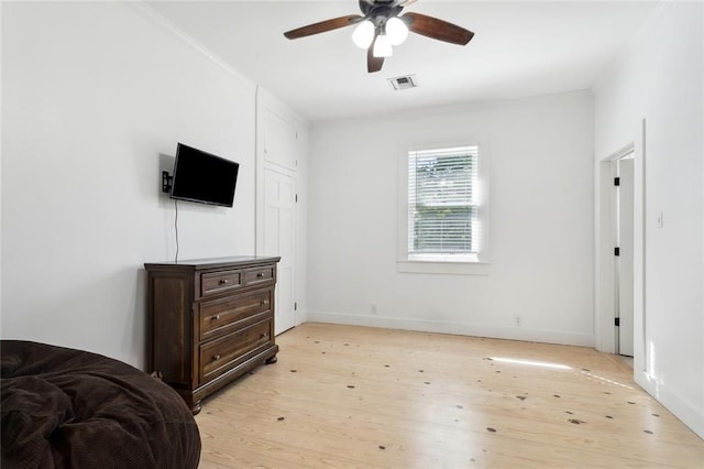 bedroom with light hardwood / wood-style floors and ceiling fan